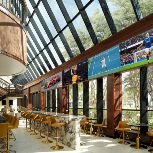 A modern cafe with brick walls, wooden tables, and a long colorful bookshelf wall, featuring warm lighting and a cozy seating area.