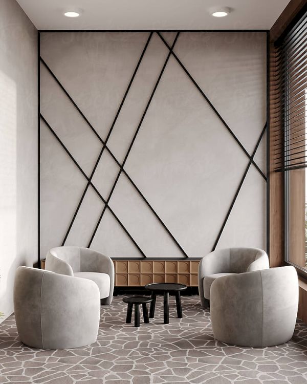 A modern sitting area with four gray chairs around small tables, a potted plant, decorative wall patterns, and large windows.